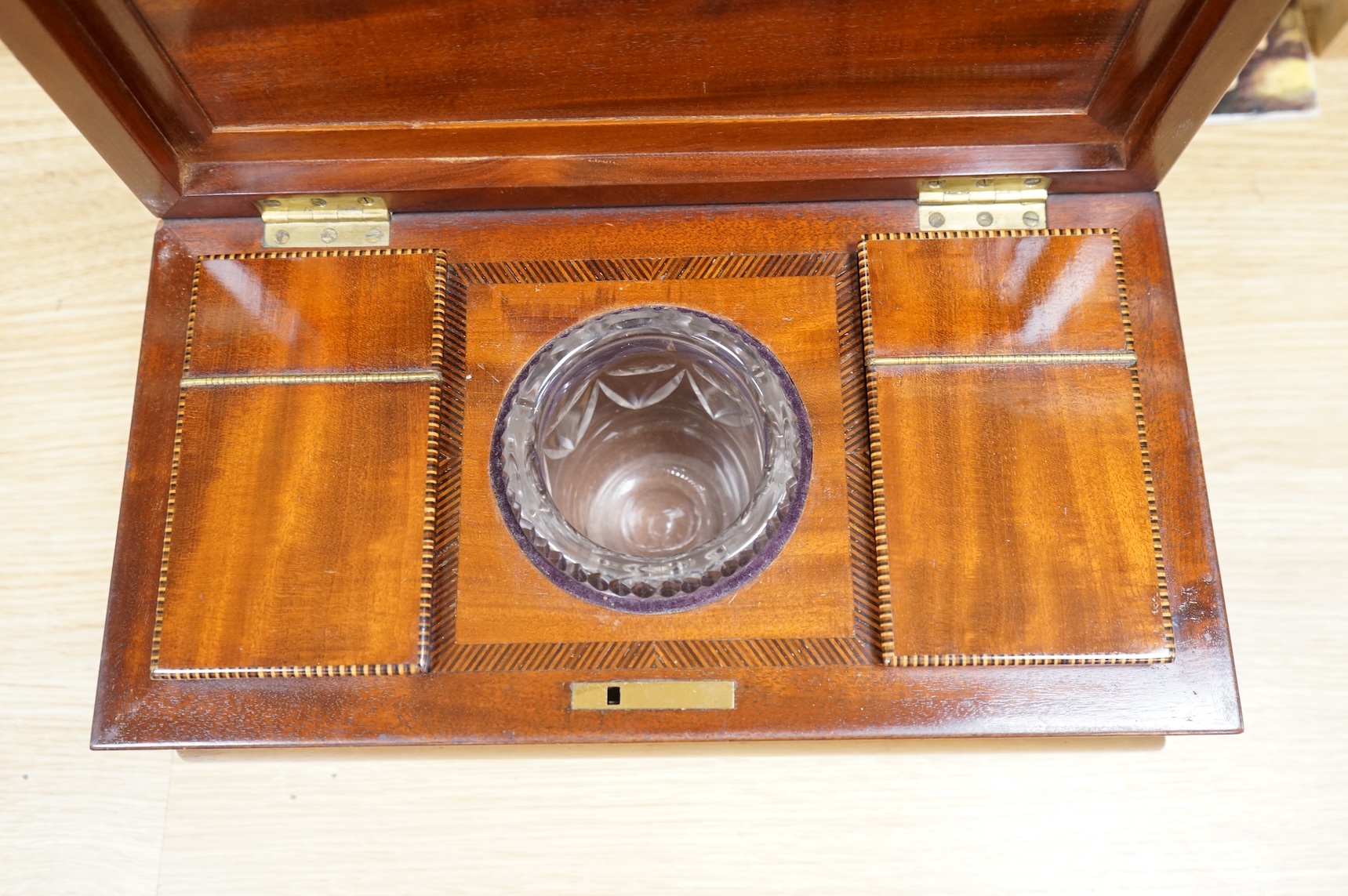 A 19th century mahogany sarcophagus tea caddy, with interior fittings, 35cm wide x 15.5cm high